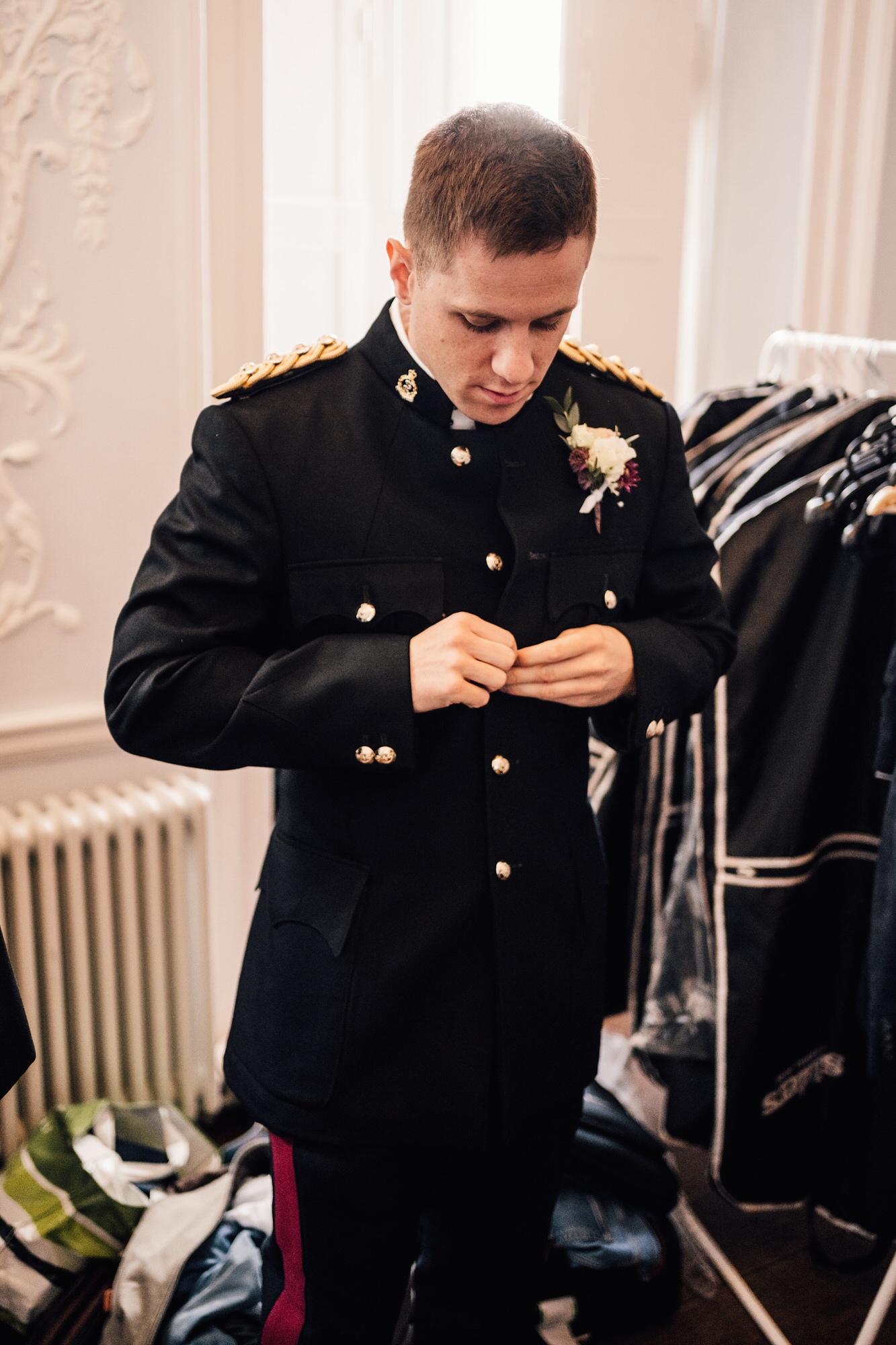 Groom getting ready in military uniform 