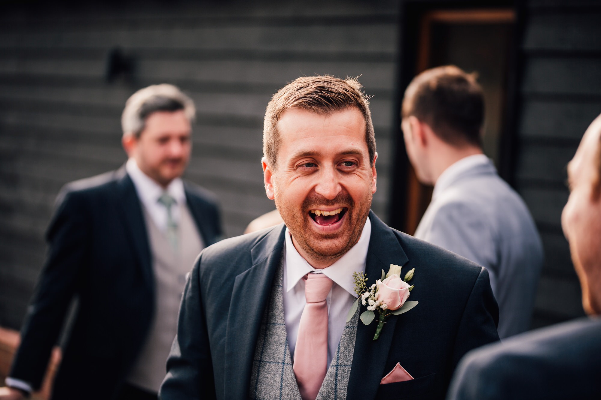 candid photo of groom laughing
