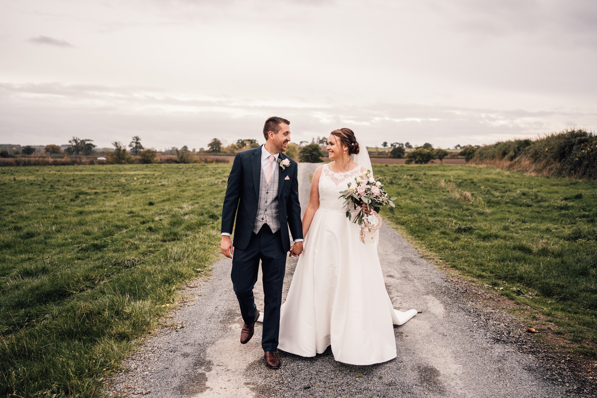 relaxed portrait of bride and groom holding hands