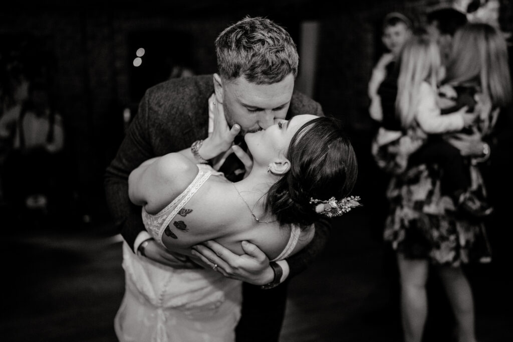 bride and groom kissing during first dance 
