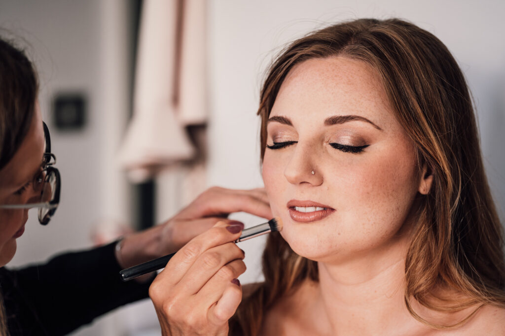 bride getting her makeup done 